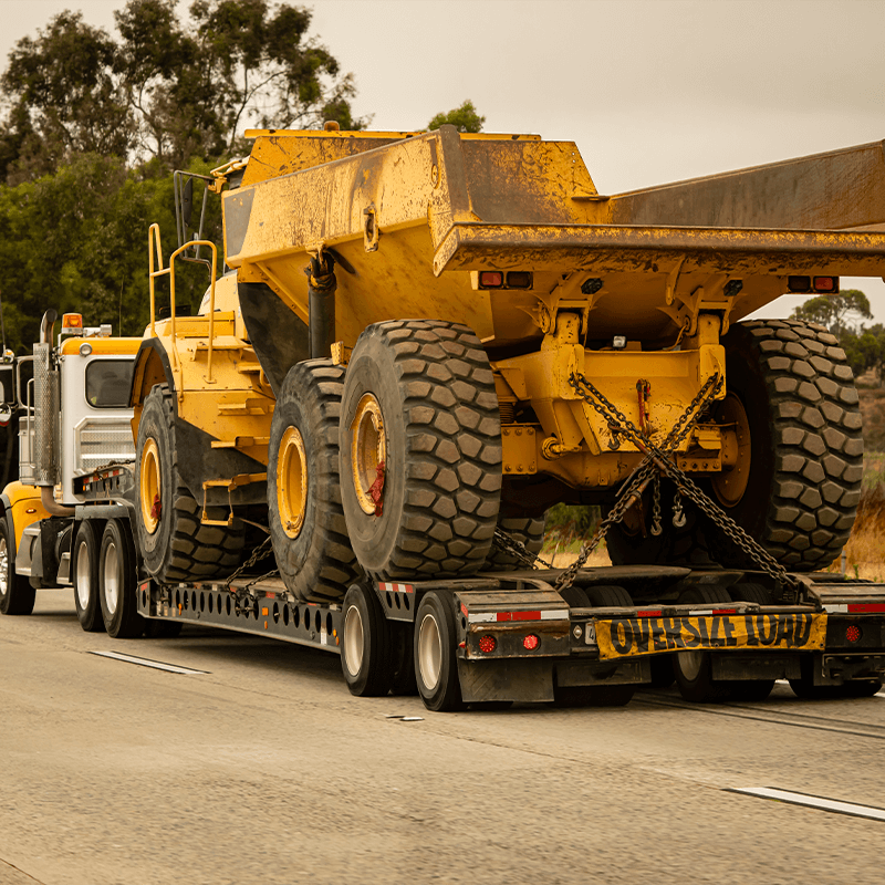trailer with an oversized load being pulled by a semitruck.